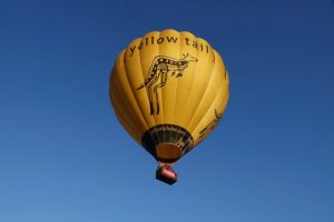 Dreams project with elderly lady and nurse caregiver hot air balloon floating in the blue sky