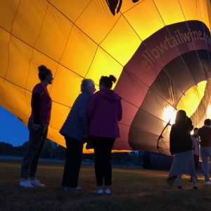 Dreams project with elderly lady and nurse caregiver watching balloon inflate