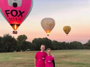 Nurse Next Door Dreams Project organisers with hot air balloons floating in sky in background