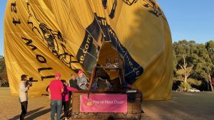 Dreams project with elderly lady being lifted out of the balloon with her caregiver nurse