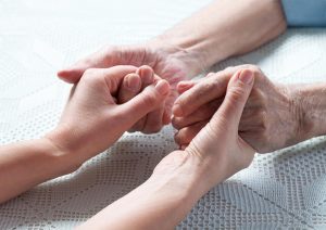 Caregiver support holding hands compressed