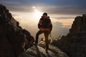 Woman recharging at the top of a mountain