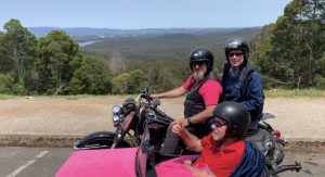 Nurse Next Door client taking a motorbike ride in the side car of a Harley Davidson with his partner and driver, John