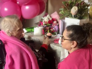 A Nurse Next Door registered nurse surprises her client with balloons and presents on her 100th birthday