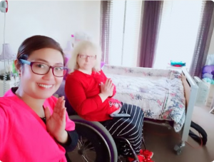 A Nurse Next Door caregiver finishes a wheelchair yoga session with her client